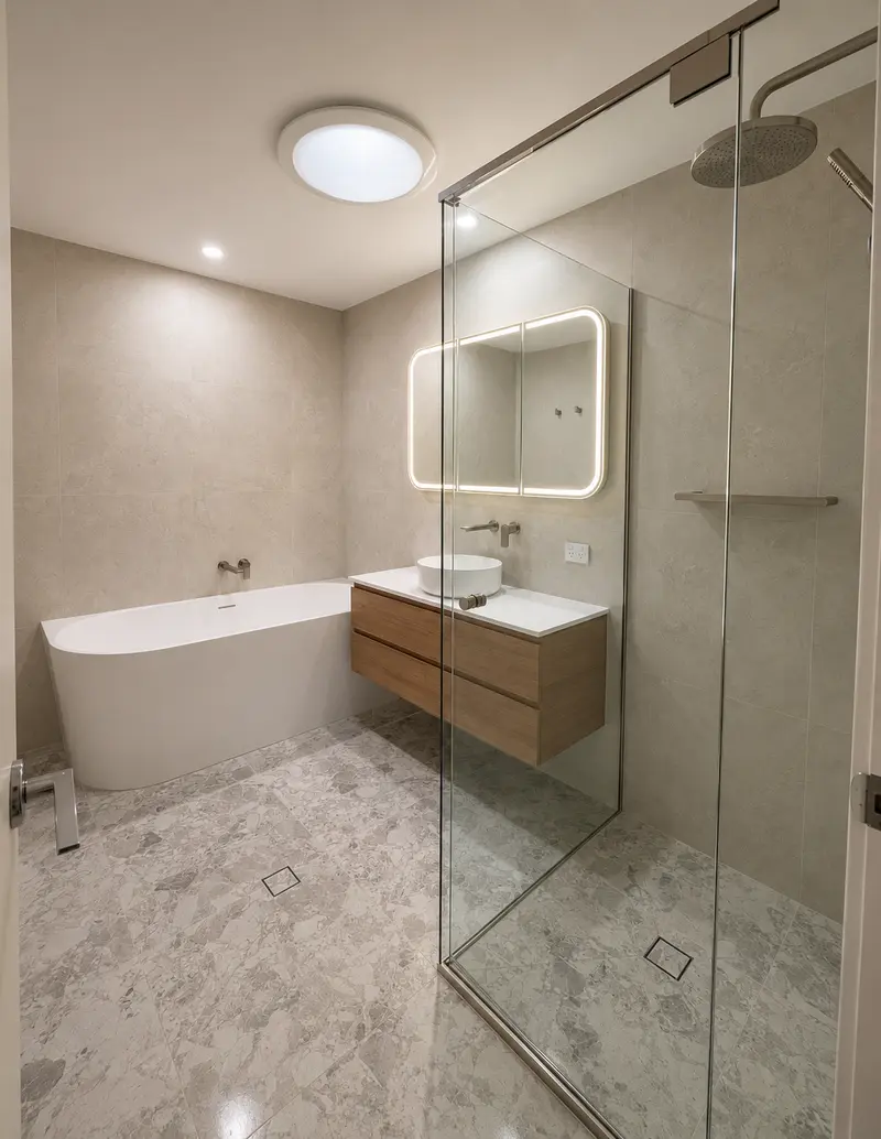 Renovated bathroom with a freestanding bath, timber vanity and brass tapware